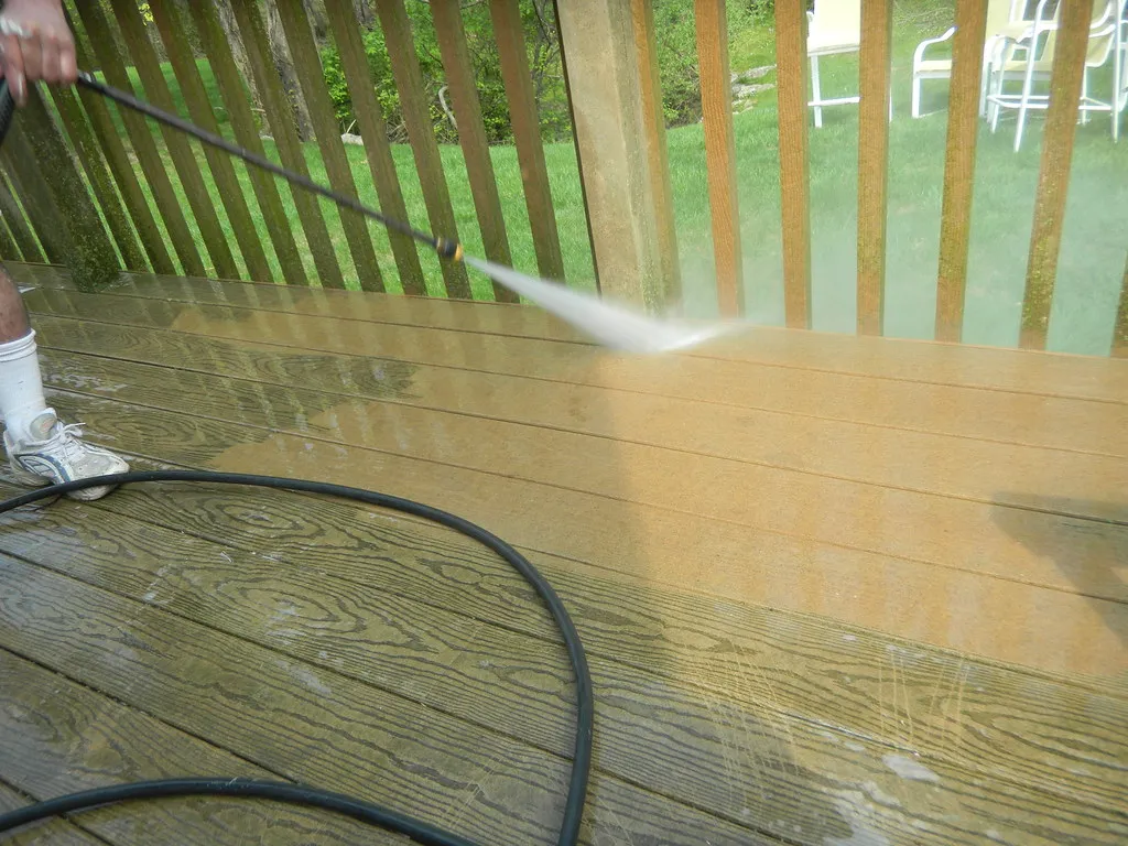 Wood deck being pressure washed